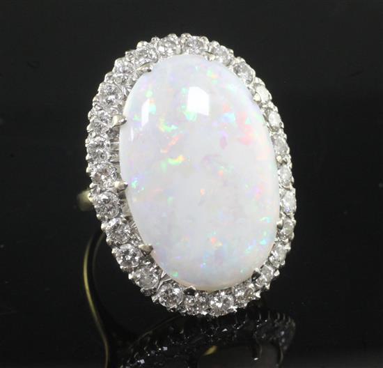 An 18ct gold, white opal and diamond oval cluster ring, size K.